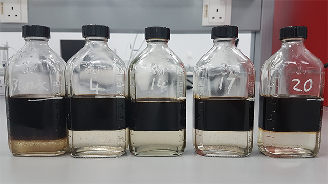 Demulsifier bottle test showing water separation across blends